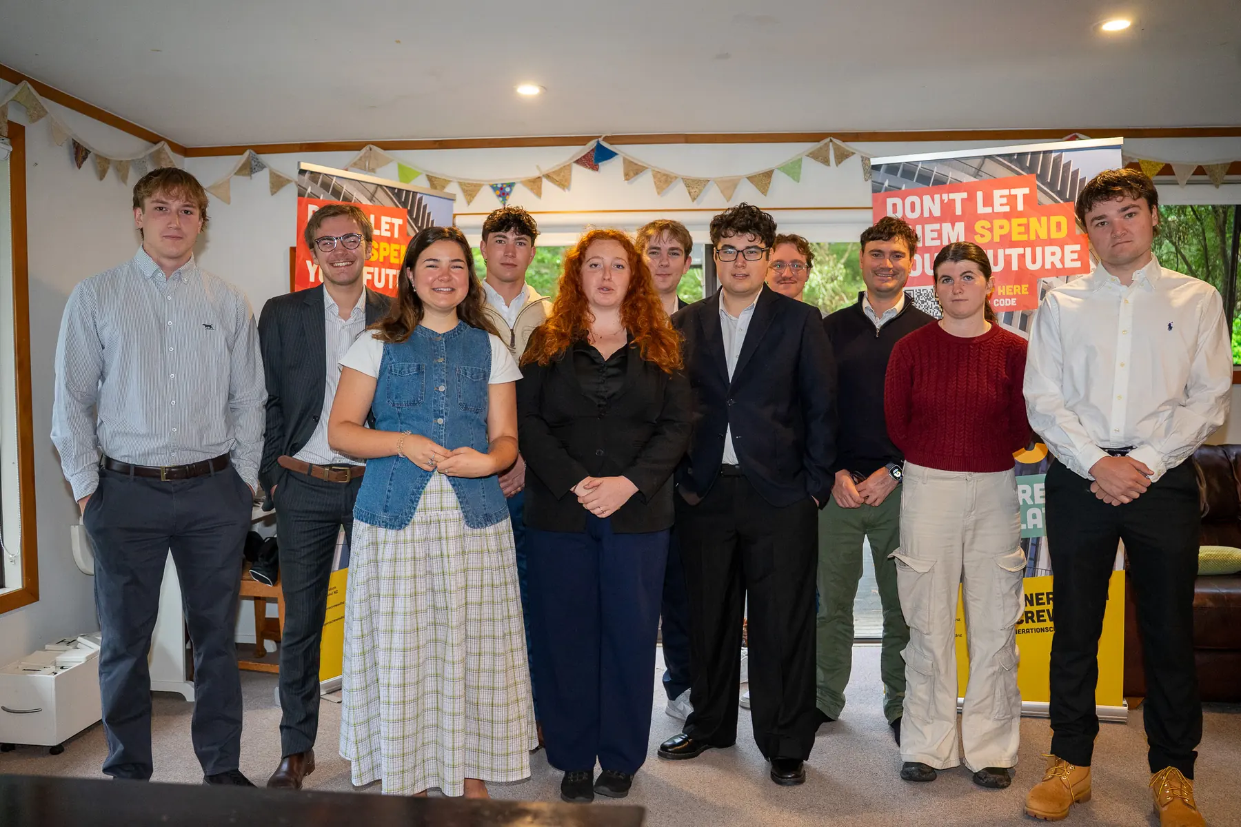Group portrait indoors with banners in the background