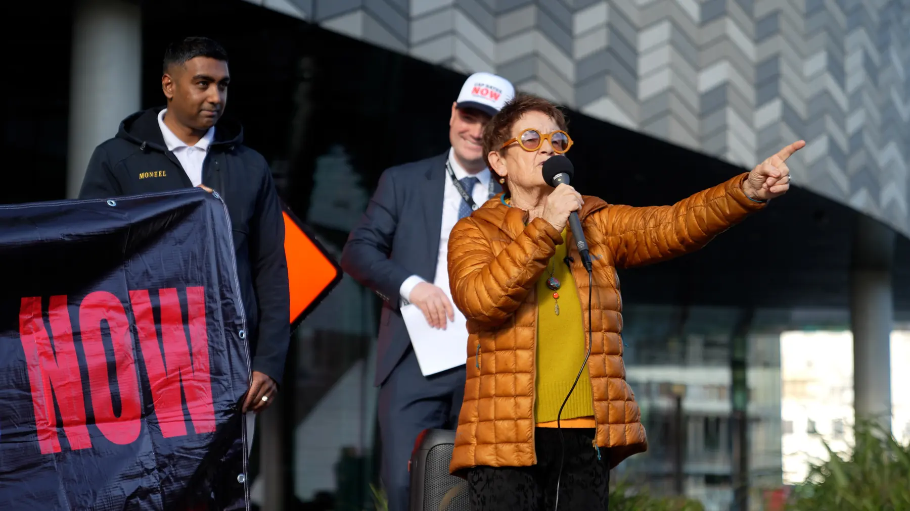 Woman speaking outdoors with microphone